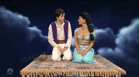 Pete Davidson dressed as Aladdin and Kim Kardashian as Jasmine kiss on a magic carpet