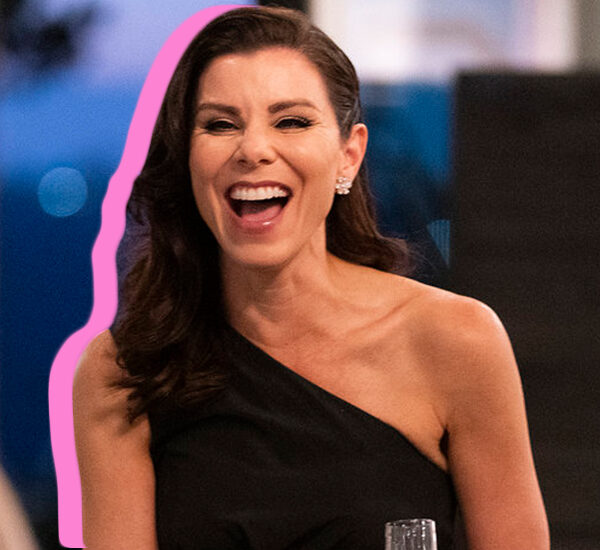 Heather Dubrow in a black one-shoulder top, laughing