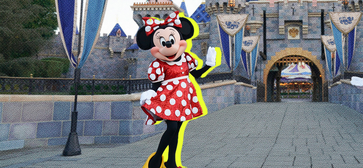 Minnie Mouse in her red polka dot dress, waving