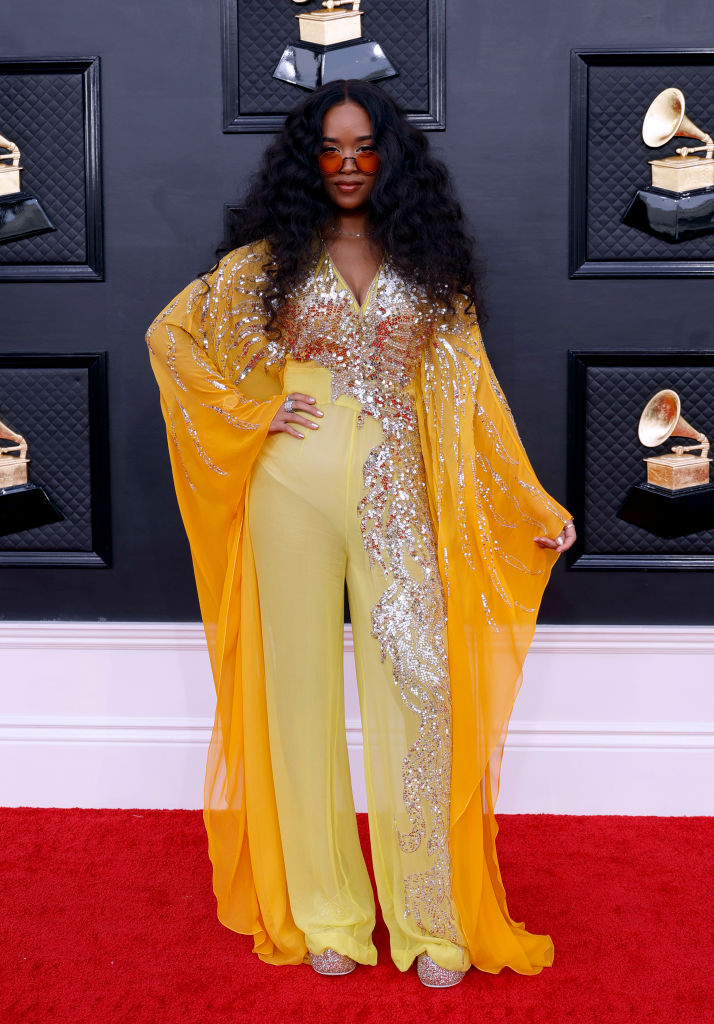 H.E.R. at the 64th annual grammys in a yellow sequined jumpsuit