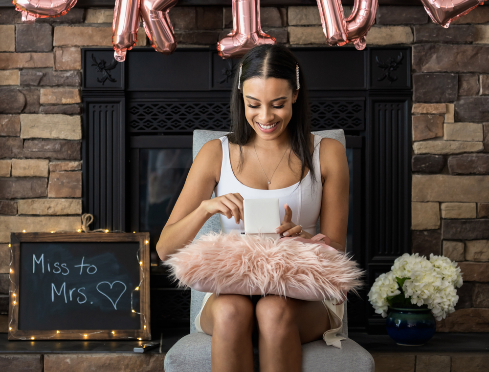 Young,Smiling,Woman,Opening,A,Gift,Box,At,Her,Bridal
