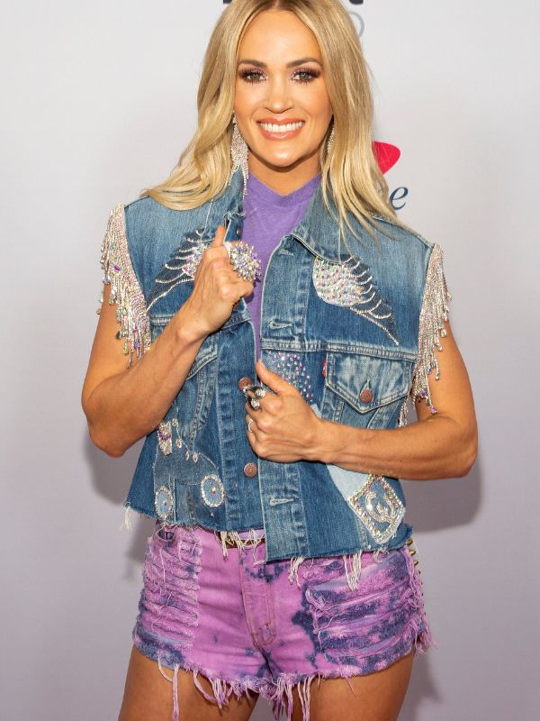 Carrie Underwood wearing purple dyed denim shorts to a music event