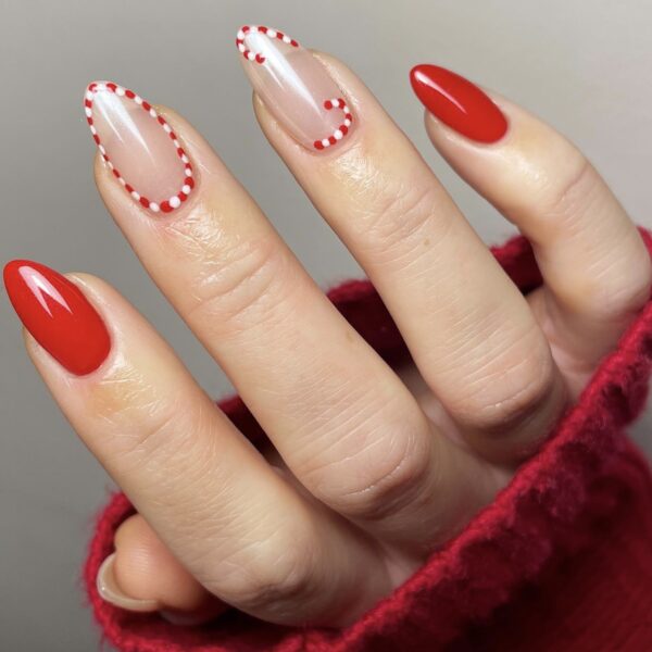A manicure with little candy canes one the middle and ring finger
