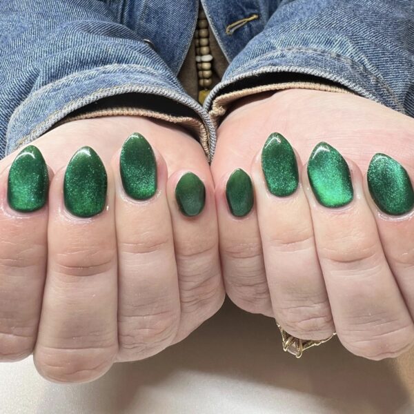 a woman showing off her green nails