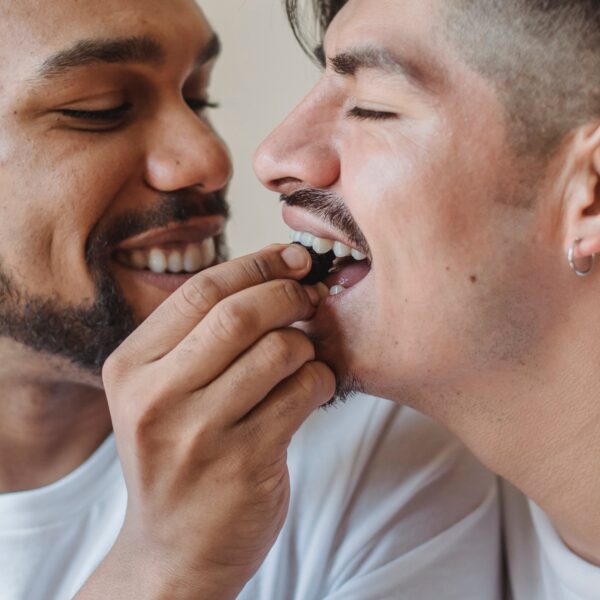 men feeding each other chocolate