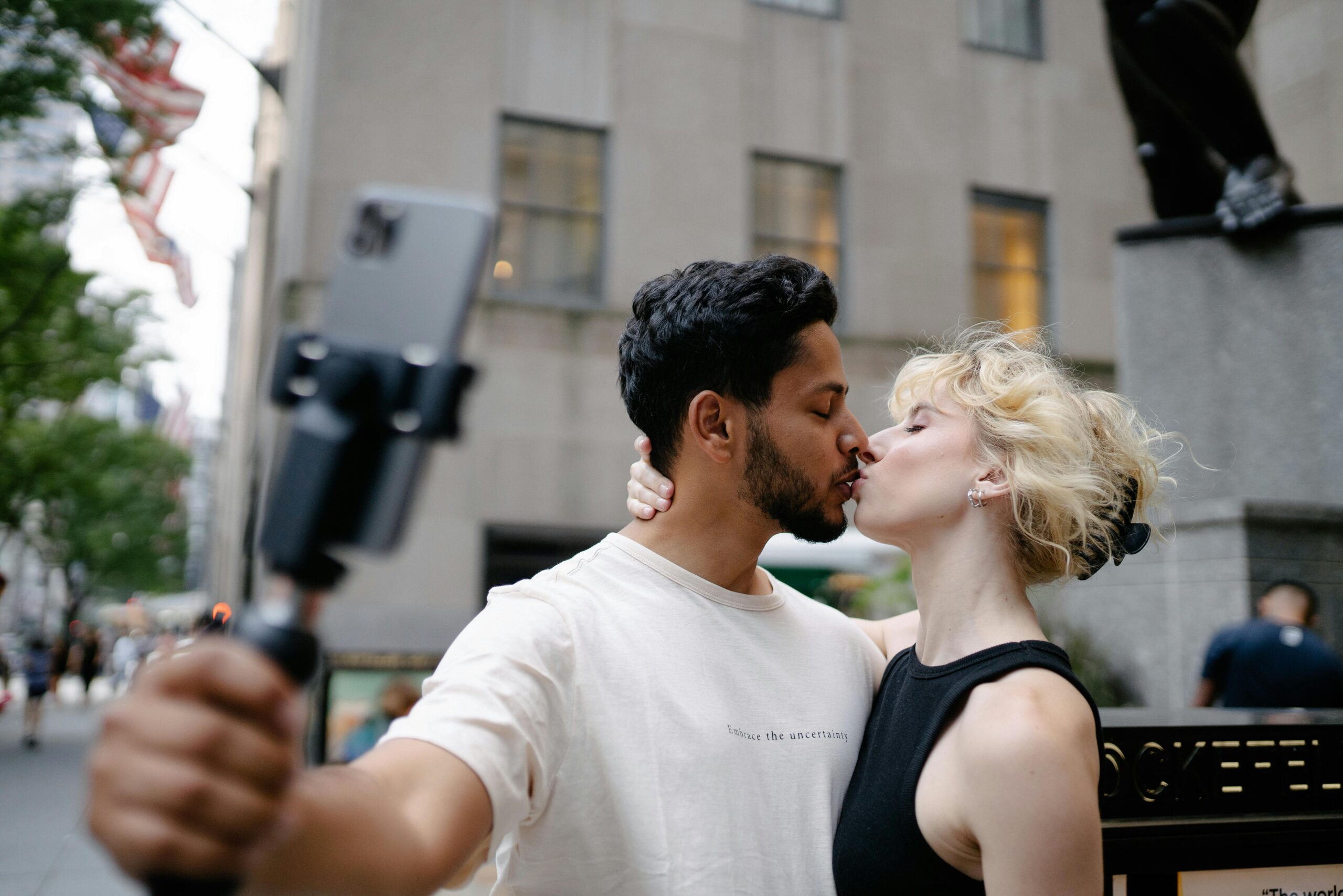 couple kissing taking selfie
