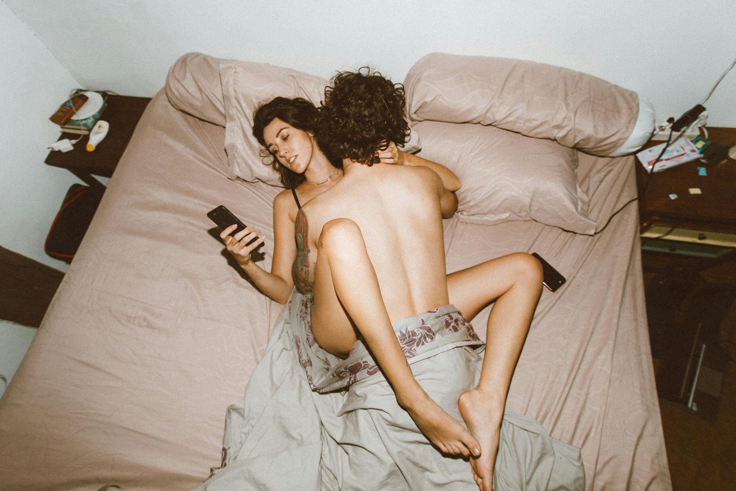 couple on bed woman on phone