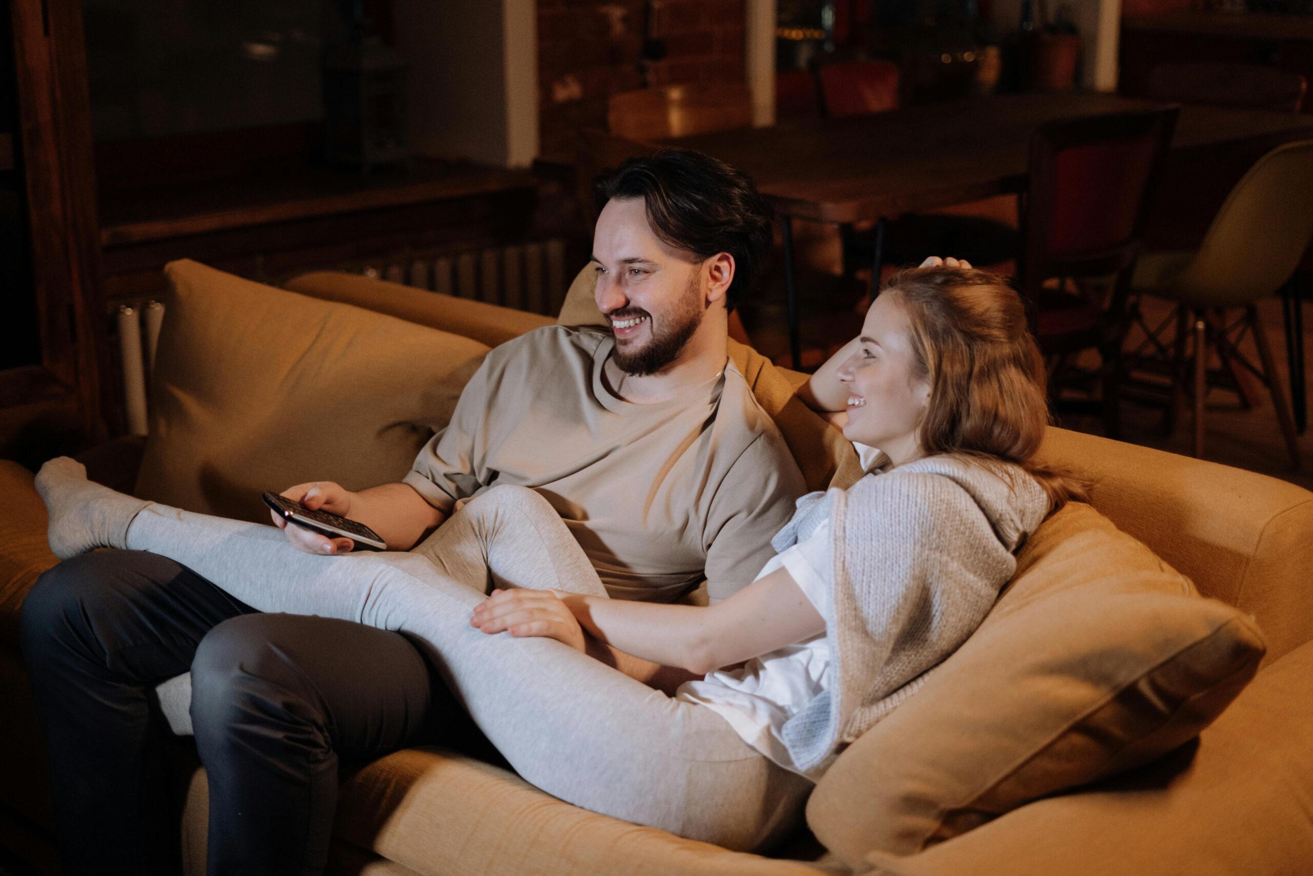 couple watching tv on couch