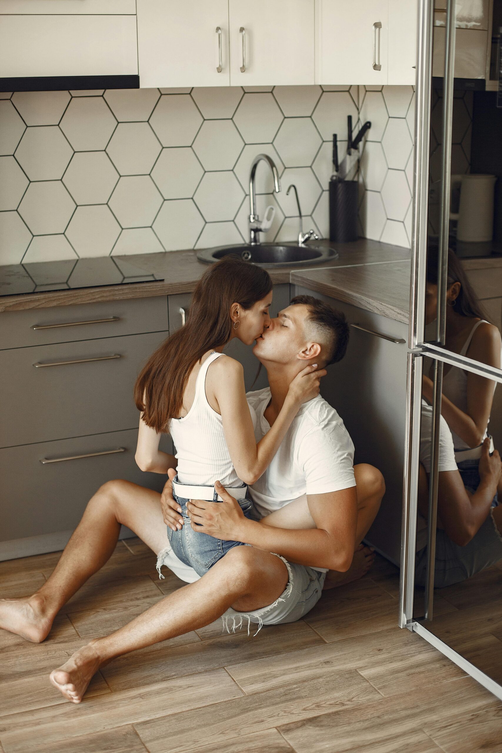 couple kissing on kitchen floor