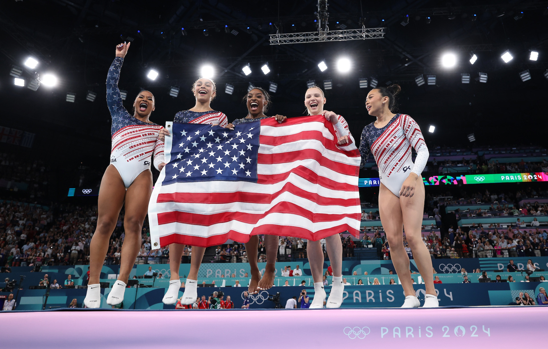 PARIS, FRANCE - JULY 30: (L-R) Jordan Chiles, Hezly Rivera, Simone Biles, Jade Carey and Sunisa Lee of Team United States celebrate winning the gold medal during the Artistic Gymnastics Women's Team Final on day four of the Olympic Games Paris 2024 at Bercy Arena on July 30, 2024 in Paris, France.