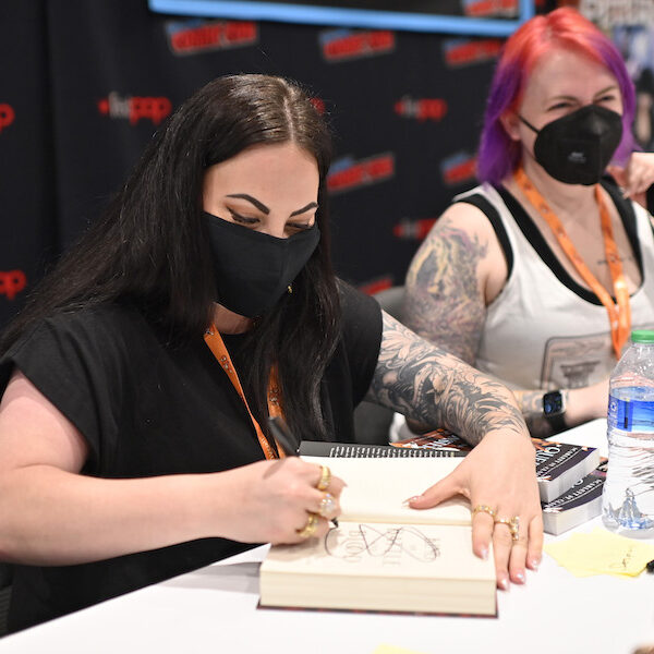 NEW YORK, NEW YORK - OCTOBER 06: Scarlett St.Clair signs memorabilia during New York Comic Con 2022 on October 06, 2022 in New York City. (Photo by Roy Rochlin/Getty Images for ReedPop)