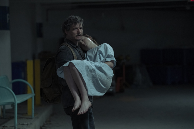 Pedro Pascal as Joel carrying Bella Ramsey as Ellie in The Last of Us season 1